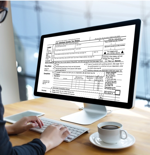 Tax accountant reviewing income tax documents representing Business Tax Preparation Services in Billings